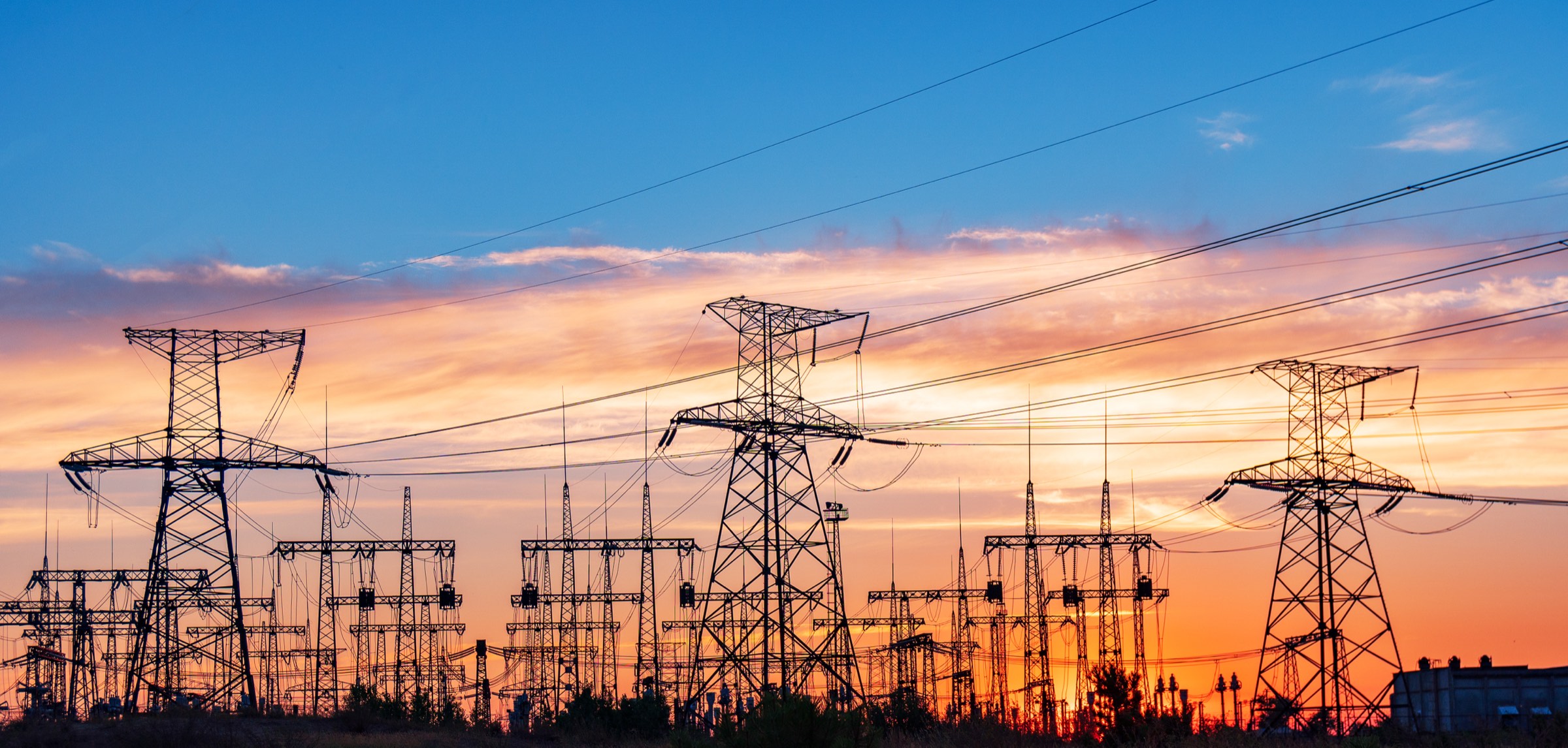 High-voltage transmission towers at dusk