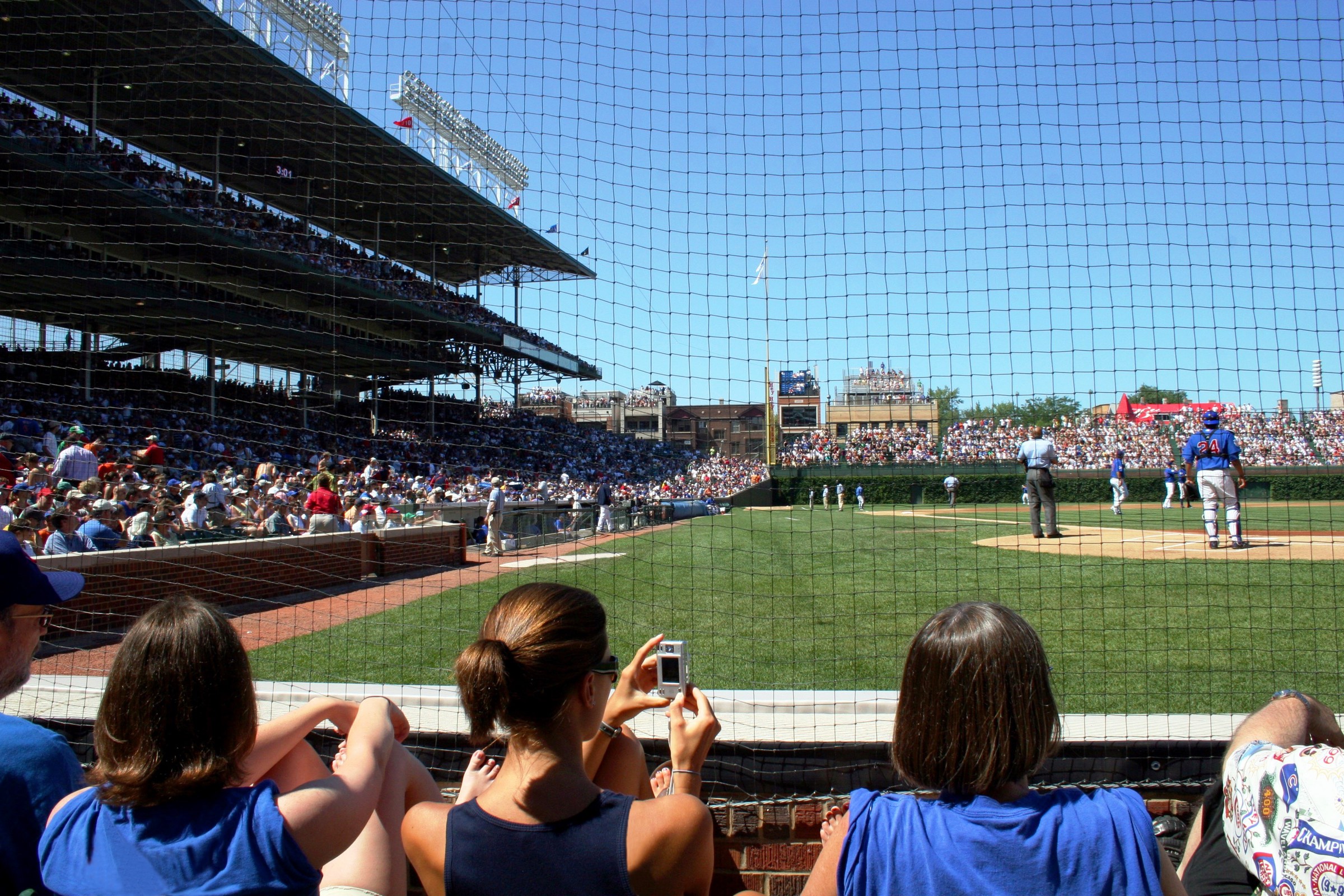 A ballpark during play, stands full